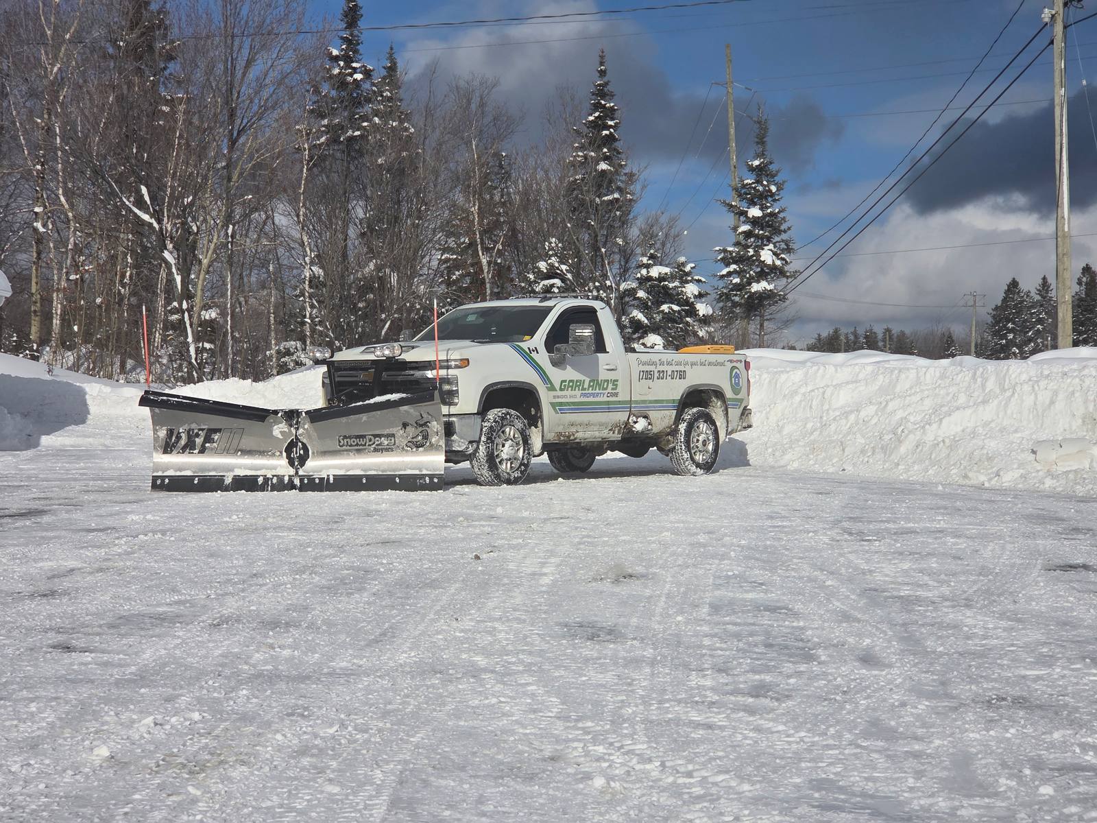 Garland's Property Care snow plow truck clearing driveway